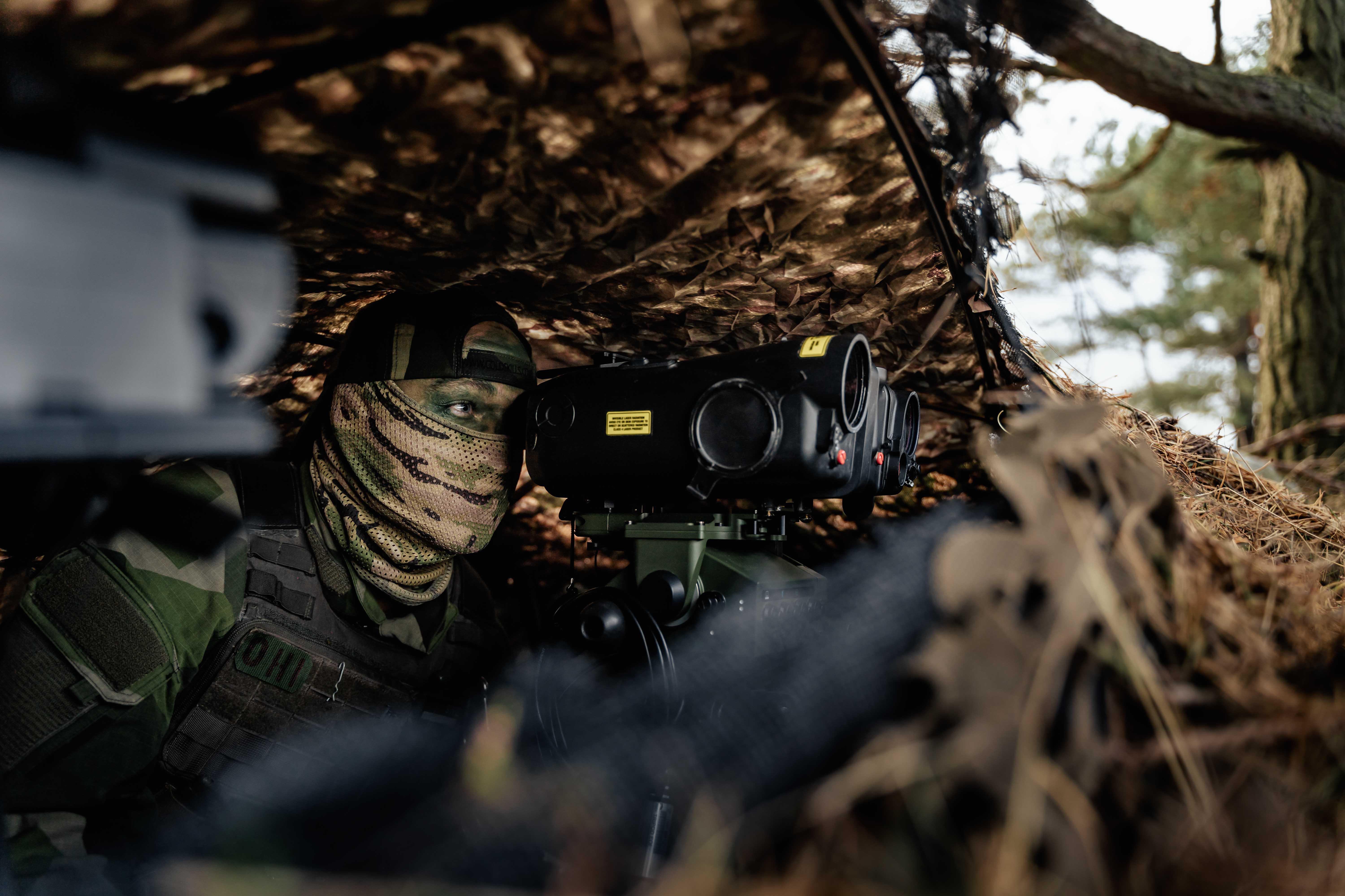 Image shows RAF Regiment using binoculars.